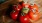 bunch of tomatoes on a wooden plate