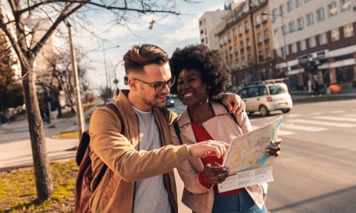 Close to the center of everything a man and woman looking at a map in the city