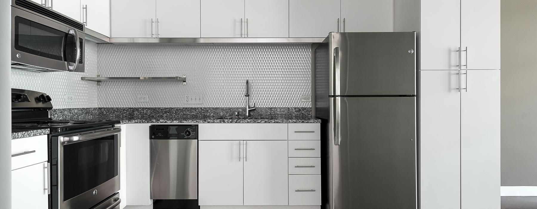 a kitchen with white cabinets