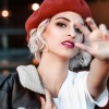 a woman holding a jacket