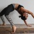 woman bending over backwards in an exercise studio