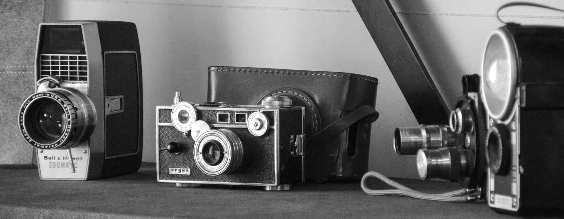 a group of cameras on a shelf