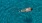 overhead shot of a woman swimming in a pool