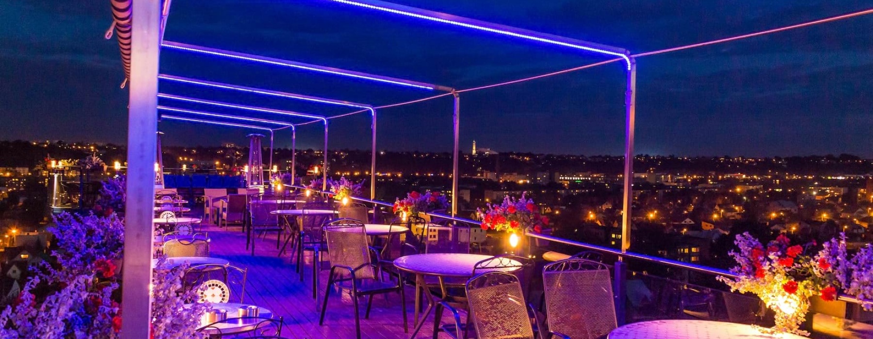 a rooftop lounge overlook a city