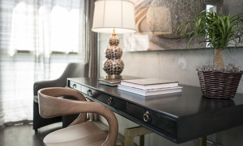 a desk with a lamp and books on it