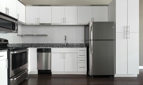 a kitchen with white cabinets